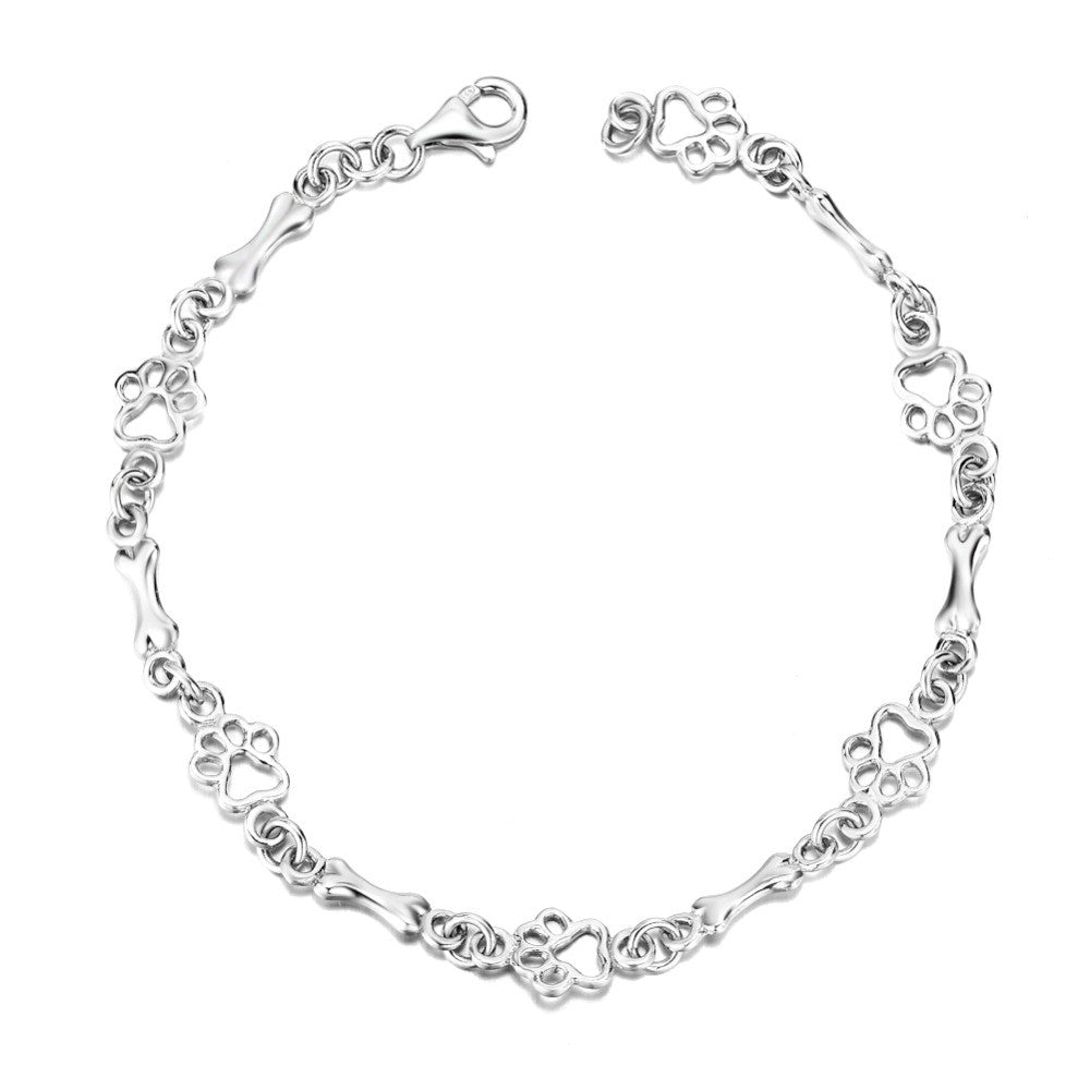 Armband mit Anhänger aus Silber mit Hundepfoten und -knochen