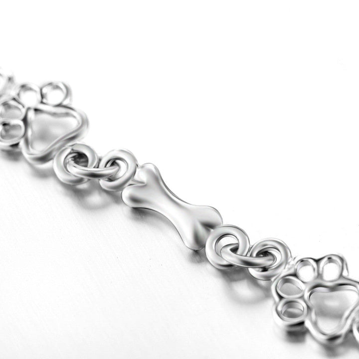 Armband mit Anhänger aus Silber mit Hundepfoten und -knochen